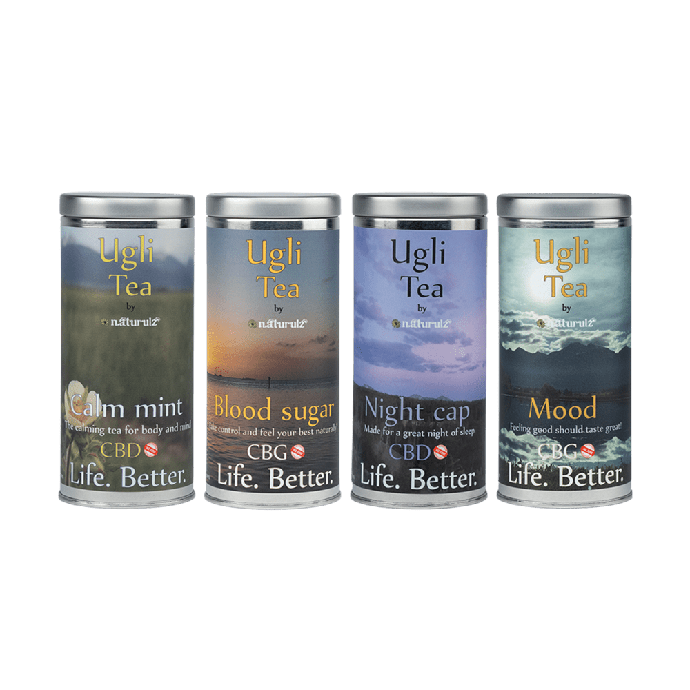 A group of four different tea cans.